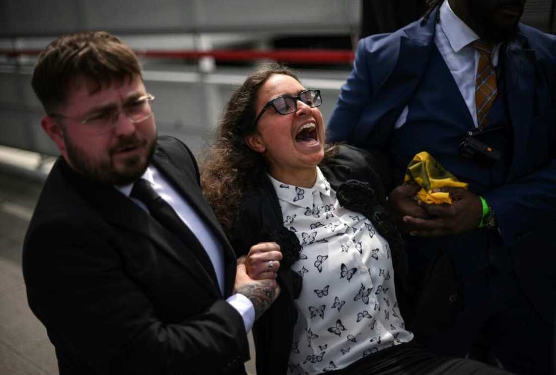 More than 100 activists disrupted the start of the shareholders' meeting before being escorted out by security More than 100 activists disrupted the start of the shareholders' meeting before being escorted out by security