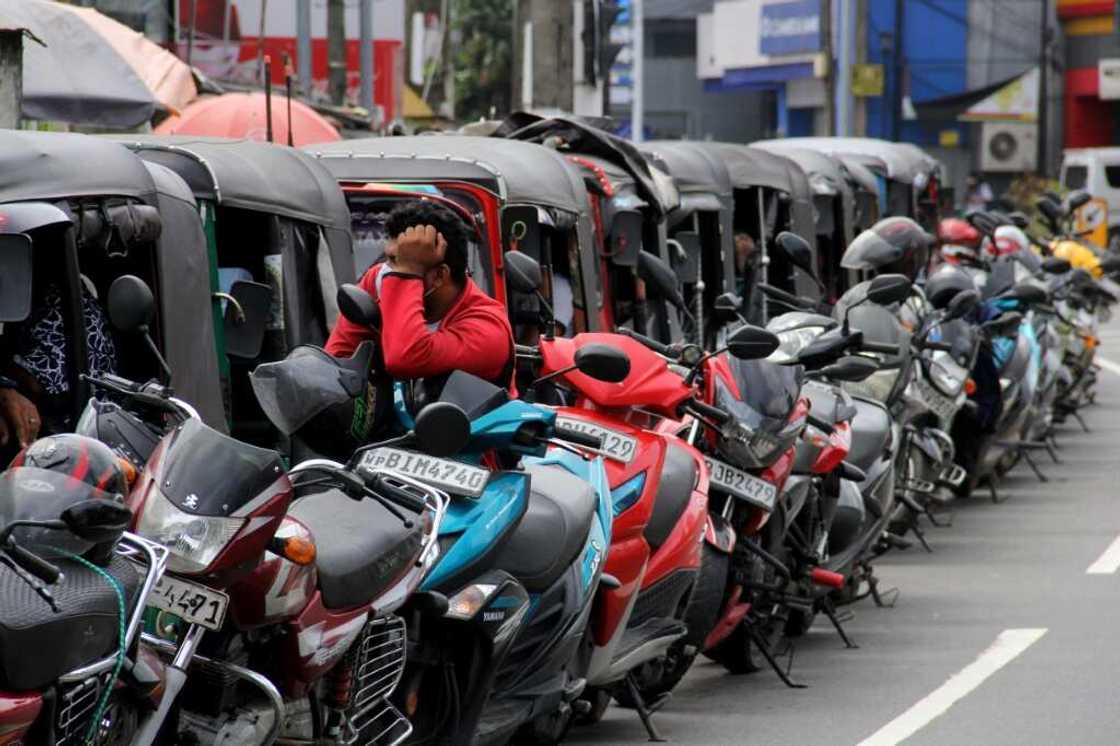 Motorists queue to buy fuel at a Ceylon petroleum corporation fuel station in Colombo