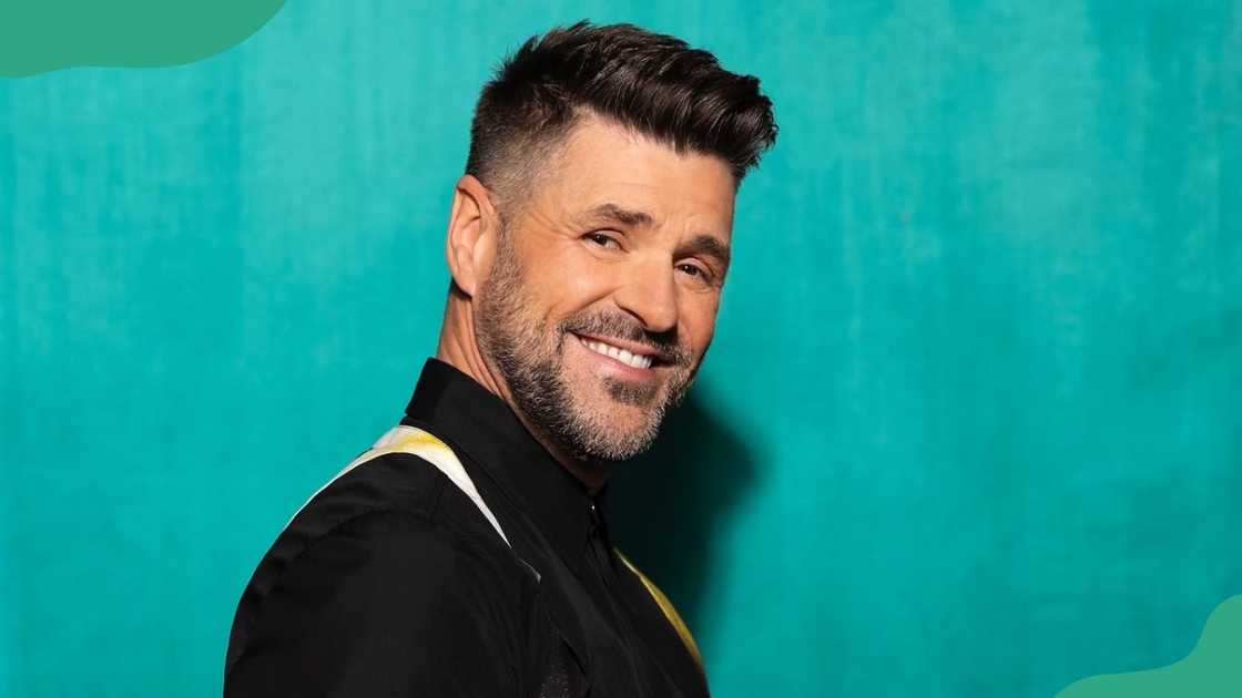 Marc Drupe in a sleek black shirt with stylish suspenders. Marc Drupe in a sleek black shirt with stylish suspenders.