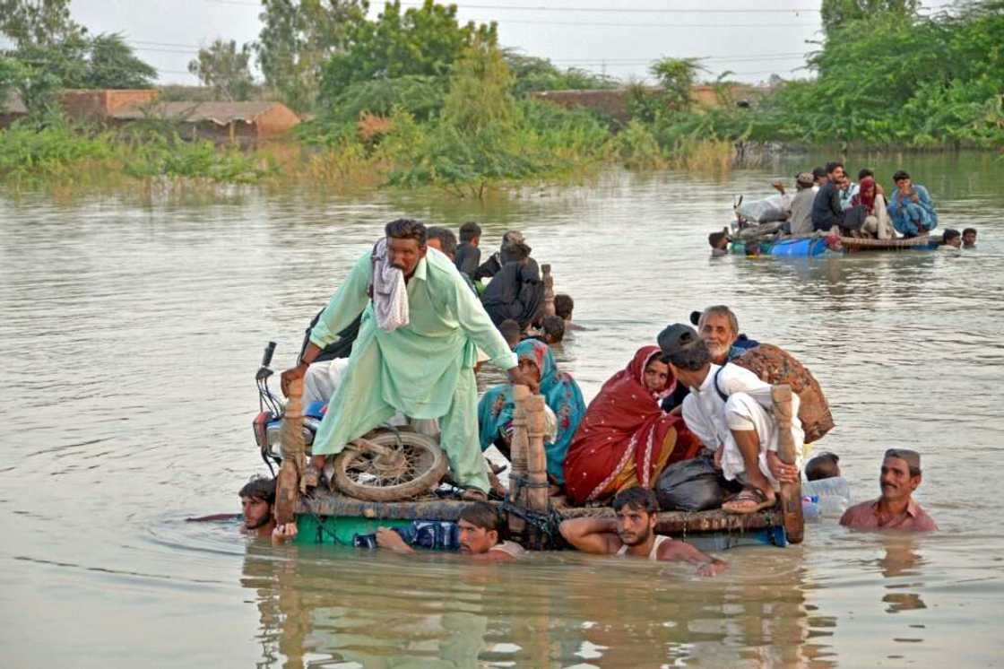 Villagers flee their homes on upturned wooden beds in the Jaffarabad district of Balochistan on Thursday Villagers flee their homes on upturned wooden beds in the Jaffarabad district of Balochistan on Thursday