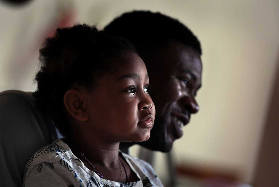 A man and his daughter sitting together