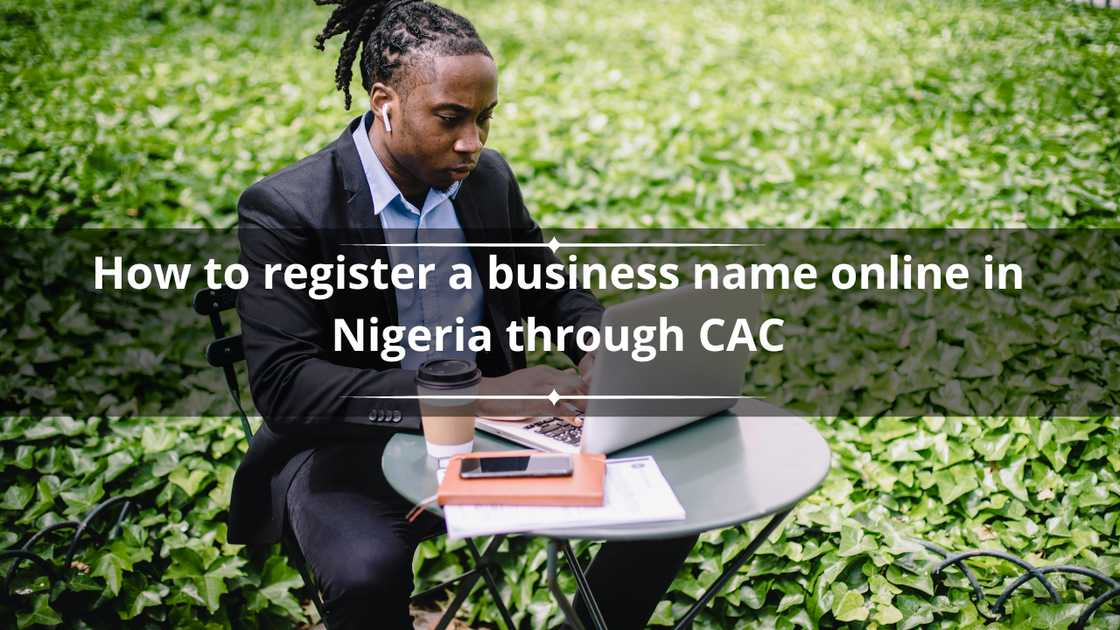 A man working on his laptop on a table outside. A man working on his laptop on a table outside.