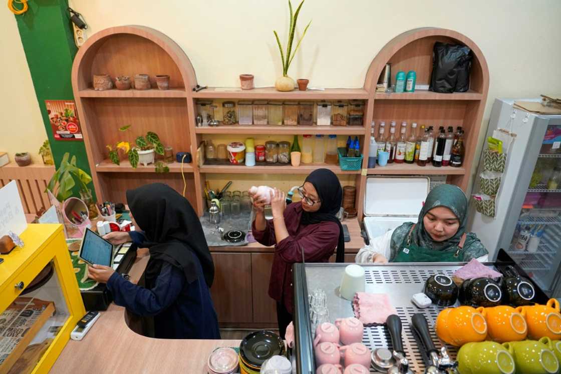 Morning Mama owner Qurrata Ayuni (R) says her Banda Aceh cafe is the only one run by a woman in the capital of Indonesia's most conservative province