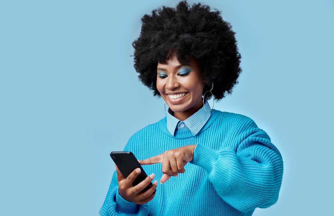 A woman using a phone. A woman using a phone.