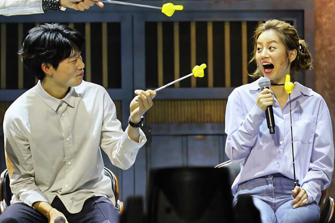 Hyeri and Ryu Jun-yeol gesture on stage