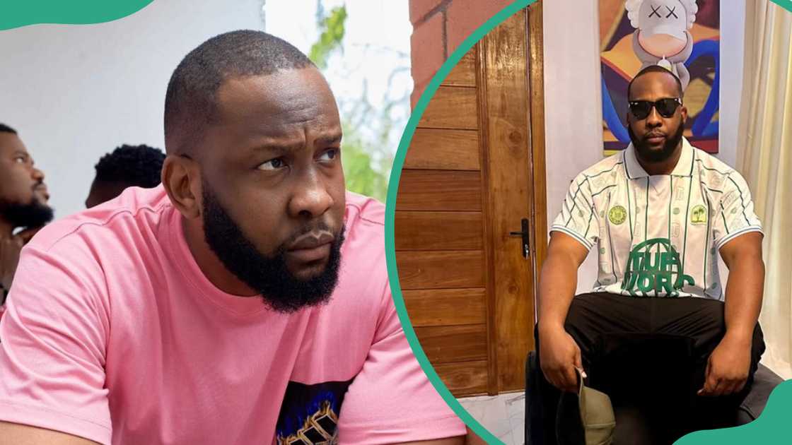 Ray Emodi, wearing a pink shirt and seated at his home