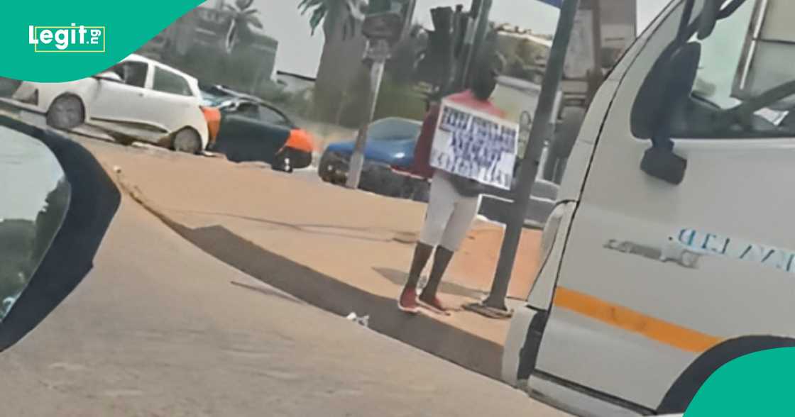 Man spotted with placard on street as he begs for car to use for work Man spotted with placard on street as he begs for car to use for work
