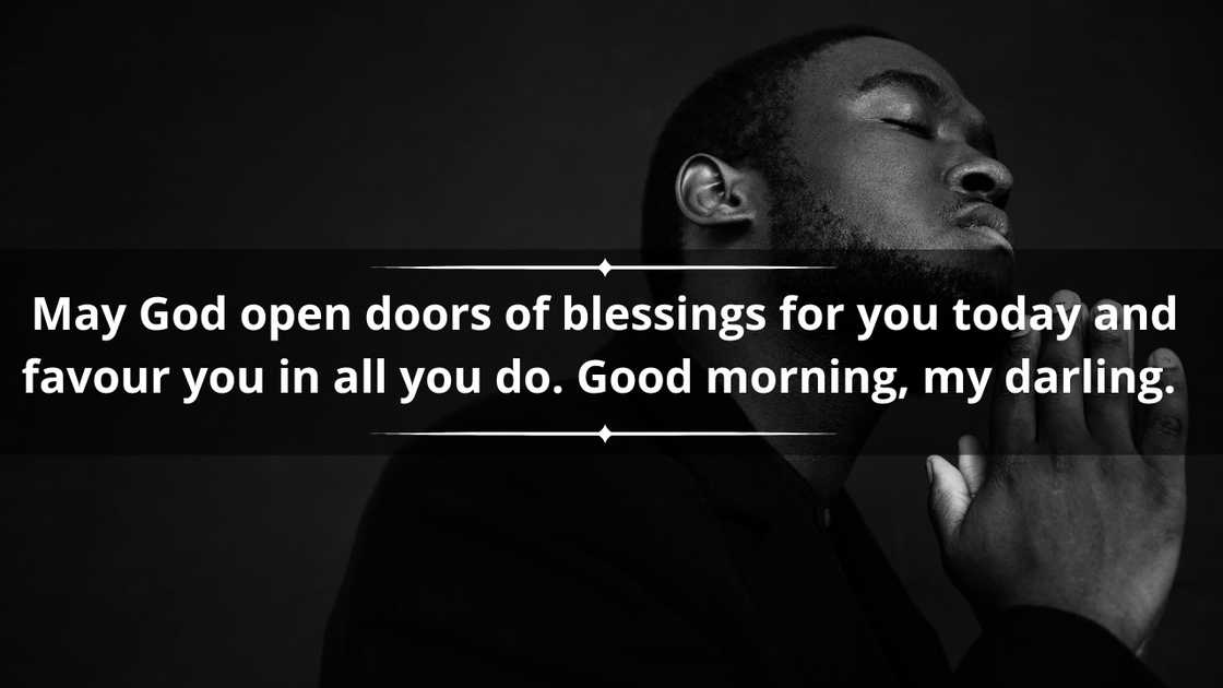 A black man in a black outfit is pictured praying with his eyes closed A black man in a black outfit is pictured praying with his eyes closed