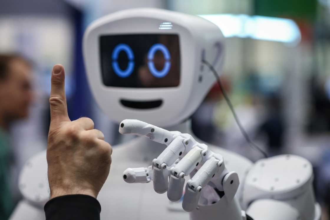 A man interacts with humanoid robot at the booth of the German Federal Ministry of Education and Research during the opening of the Hannover Messe A man interacts with humanoid robot at the booth of the German Federal Ministry of Education and Research during the opening of the Hannover Messe