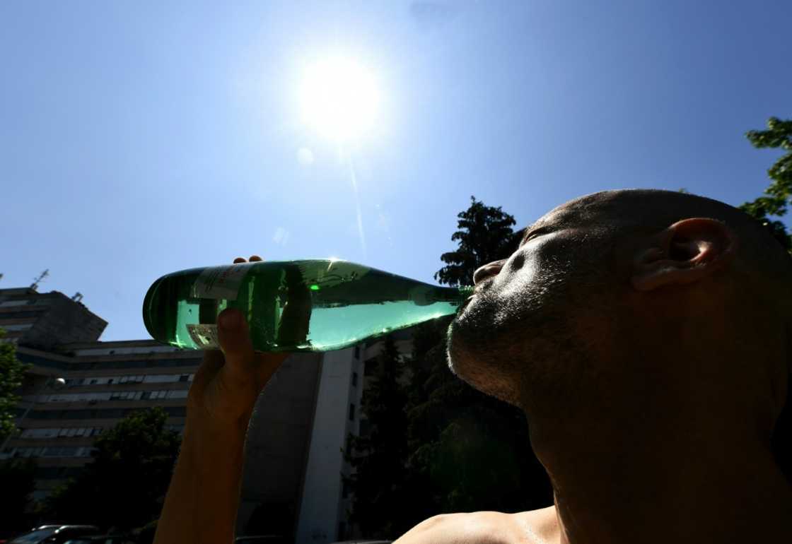  A man drinks as the Croatian capital Zagreb bakes during a heat wave