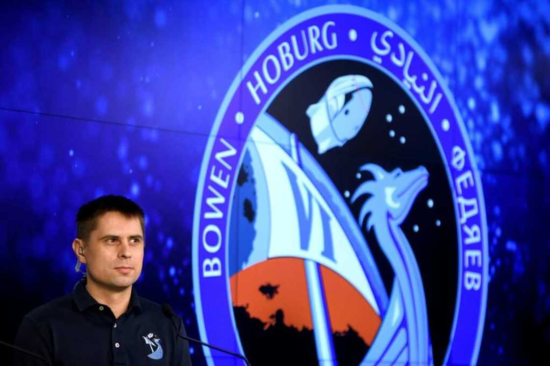 Russian cosmonaut Andrey Fedyaev sits next to a photo of the patch bearing the names of the four members of SpaceX Dragon Crew-6 mission Russian cosmonaut Andrey Fedyaev sits next to a photo of the patch bearing the names of the four members of SpaceX Dragon Crew-6 mission