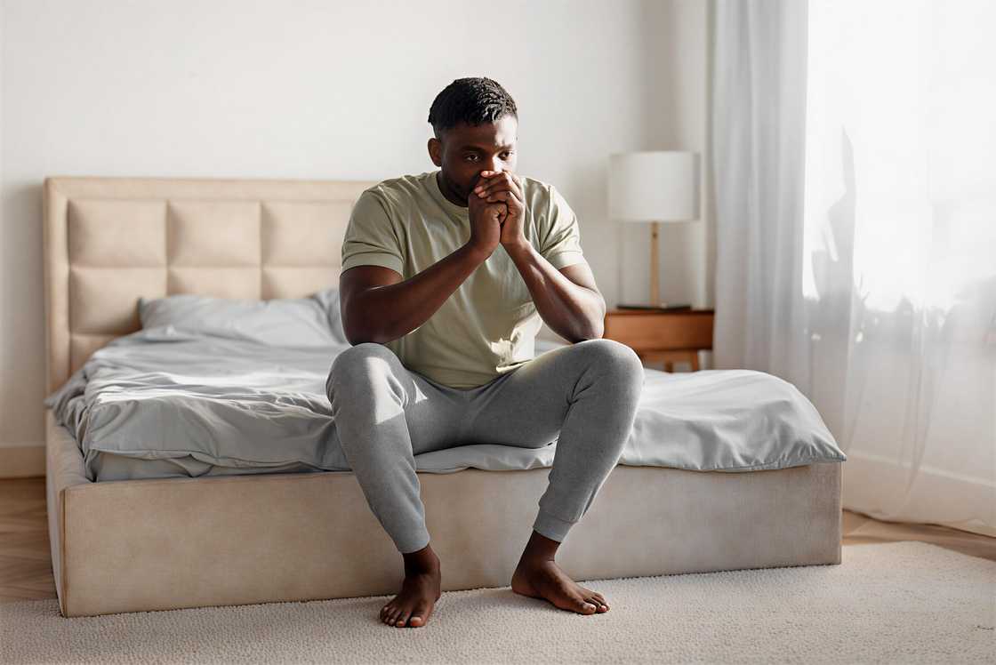 An unhappy black young guy is thinking An unhappy black young guy is thinking