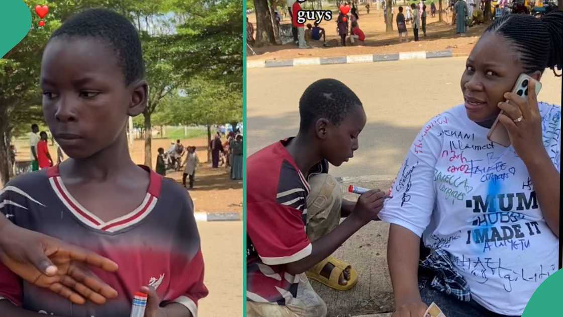 Boy signs shirt of a graduate.