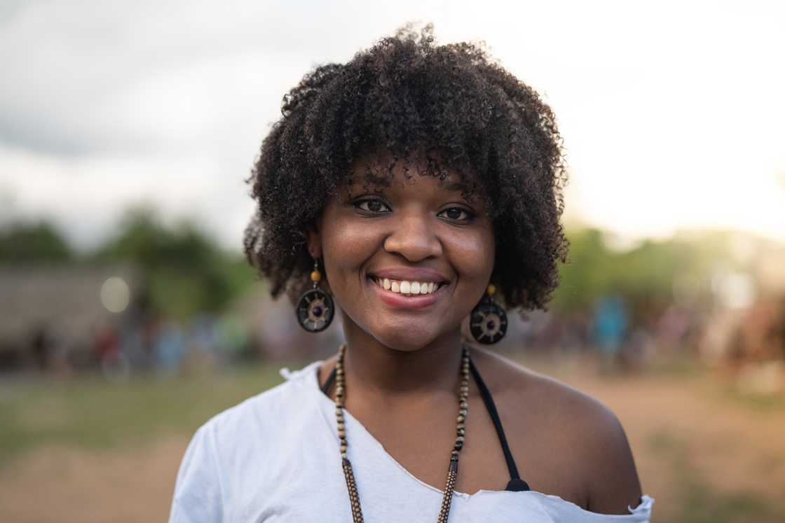 Smiling woman outdoors in Nigeria.