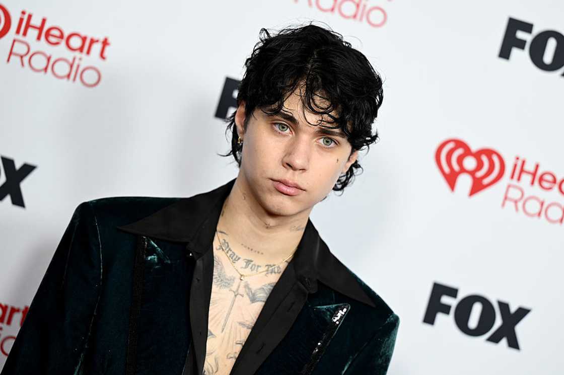 Landon Barker shows off chest tattoos in an open velvet jacket at the iHeartRadio Music Awards. Landon Barker shows off chest tattoos in an open velvet jacket at the iHeartRadio Music Awards.
