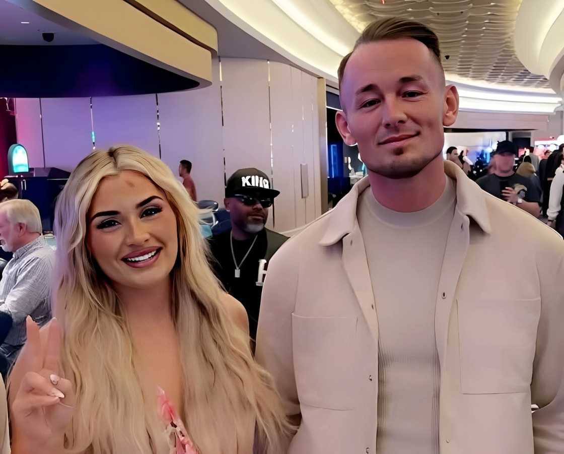 Tiffany Stratton rasing her two fingers smiling and Ludwig Kaiser smiling softly Tiffany Stratton rasing her two fingers smiling and Ludwig Kaiser smiling softly