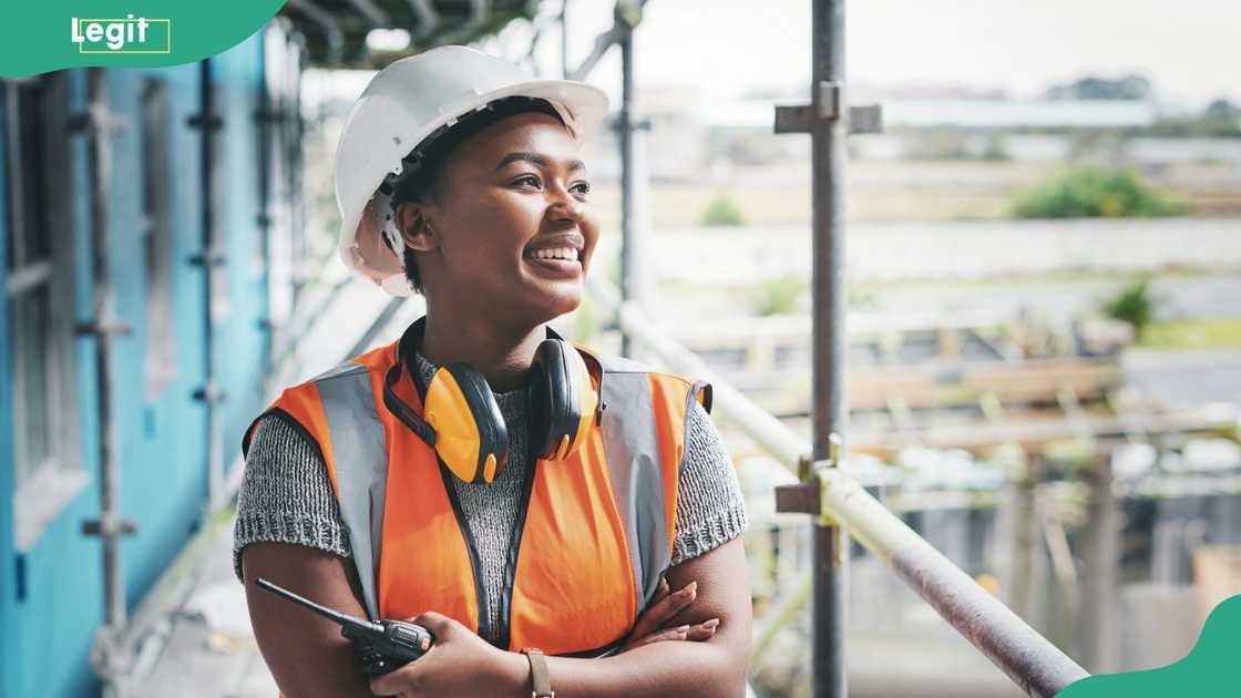 A young woman working at a construction site A young woman working at a construction site