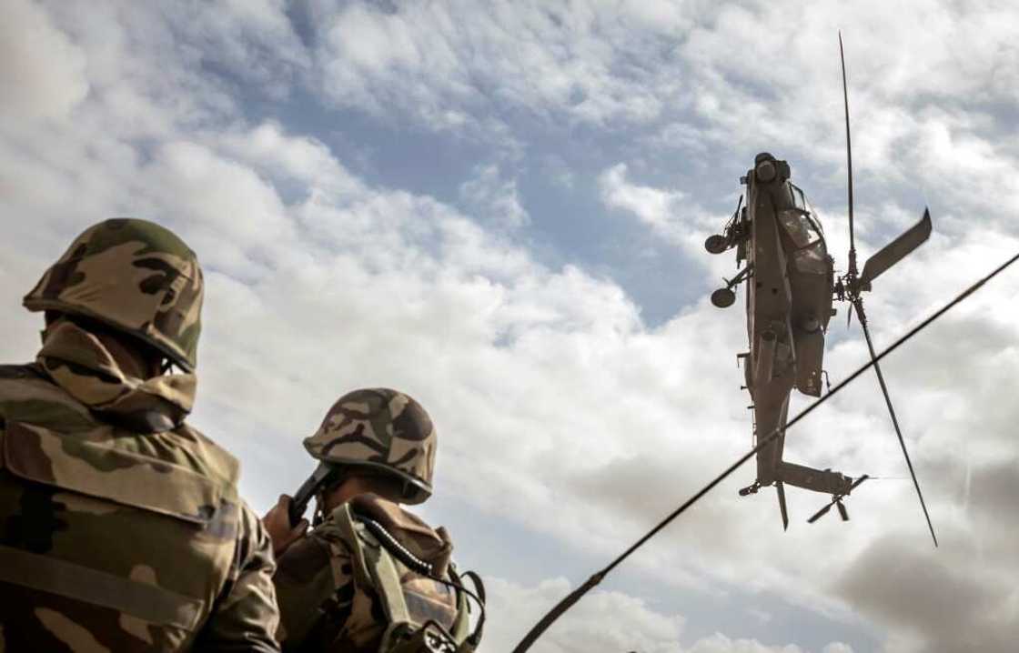 A US army AH-64 Apache attack helicopter flies over members of the Moroccan Royal Armed Forces during the second annual "African Lion" military exercise on June 30 A US army AH-64 Apache attack helicopter flies over members of the Moroccan Royal Armed Forces during the second annual "African Lion" military exercise on June 30
