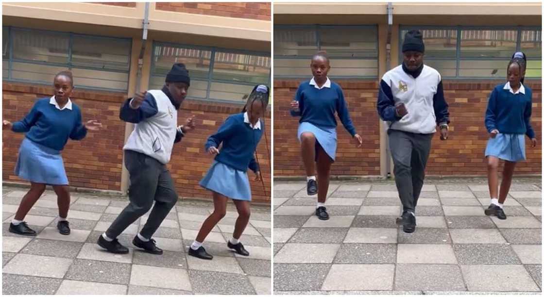 2 girls in uniform dancing with a man. 2 girls in uniform dancing with a man.