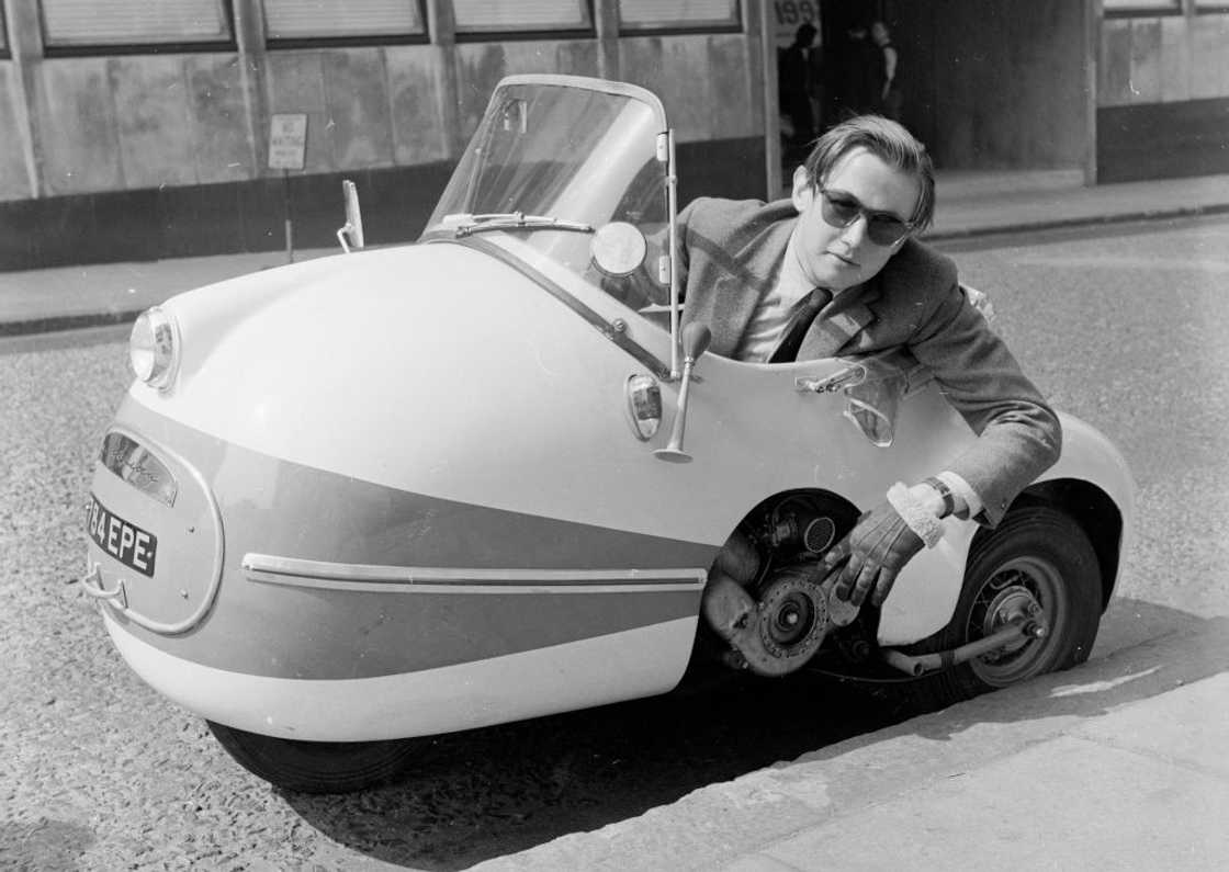 A black and white photo of a man in a Brutsch Mopetta A black and white photo of a man in a Brutsch Mopetta