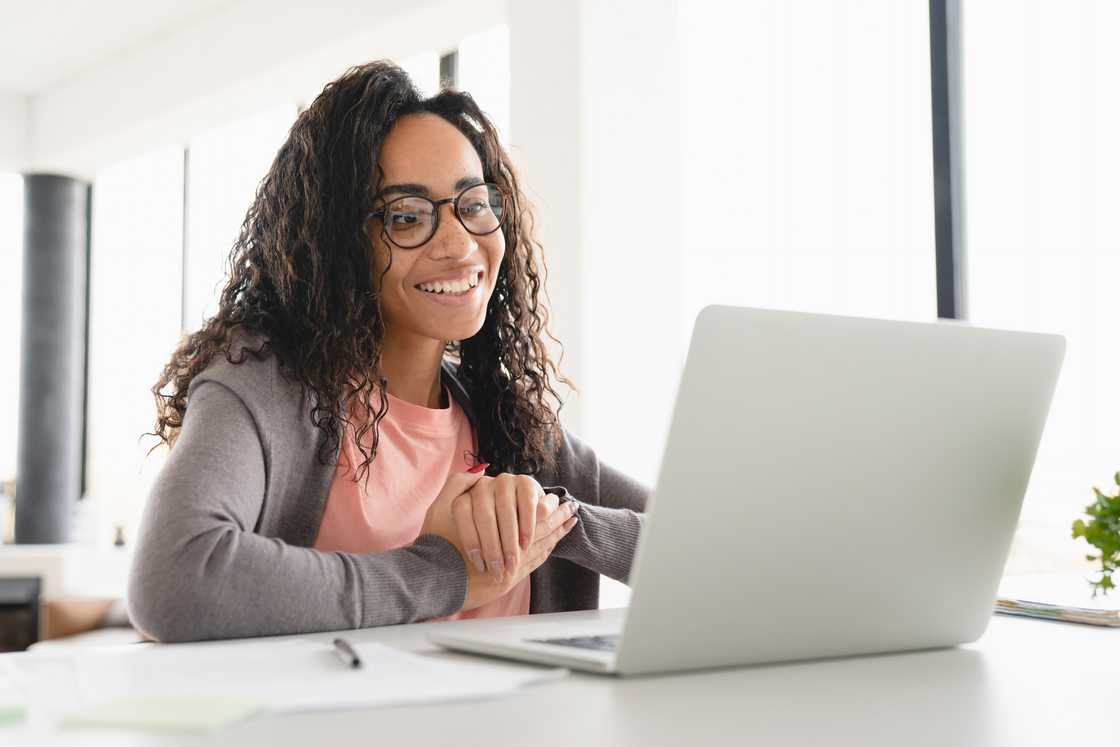 A female student watching video on a labtop. A female student watching video on a labtop.