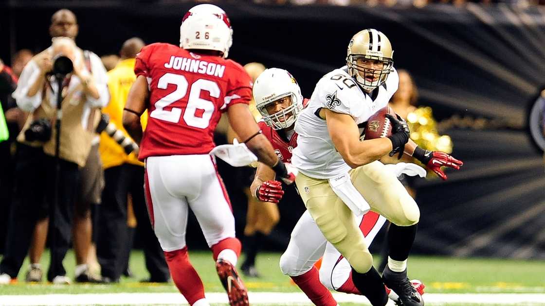 Rashad Johnson of the Arizona Cardinals (left) prepares to tackle Jimmy Graham of the New Orleans Saints (right).