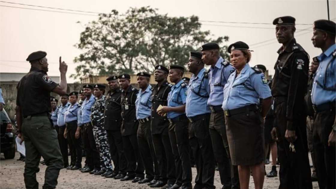 Gunmen Shoot Policeman Dead in Imo, Wife, Sister in Tears as They Recover His Remains from Gutter