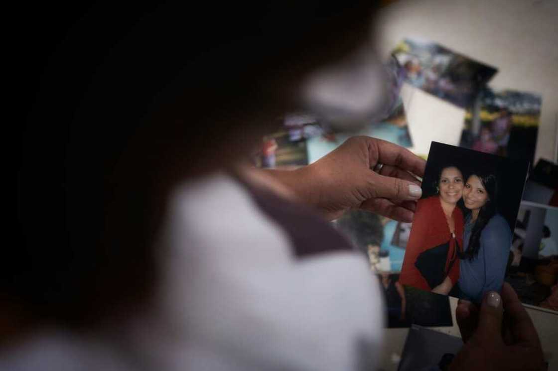 Tania de Oliveira shows a picture of her cousin Nathalia, one of the victims who remain missing five years after a mine dam collapse in the Brazilian town of Brumadinho Tania de Oliveira shows a picture of her cousin Nathalia, one of the victims who remain missing five years after a mine dam collapse in the Brazilian town of Brumadinho