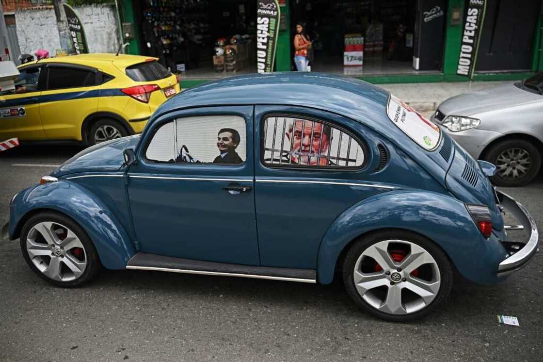 Fans of Brazilian President Jair Bolsonaro have taken to driving cars with images of him as a driver and his rival, leftist Luiz Inacio Lula da Silva, as a prisoner behind bars Fans of Brazilian President Jair Bolsonaro have taken to driving cars with images of him as a driver and his rival, leftist Luiz Inacio Lula da Silva, as a prisoner behind bars