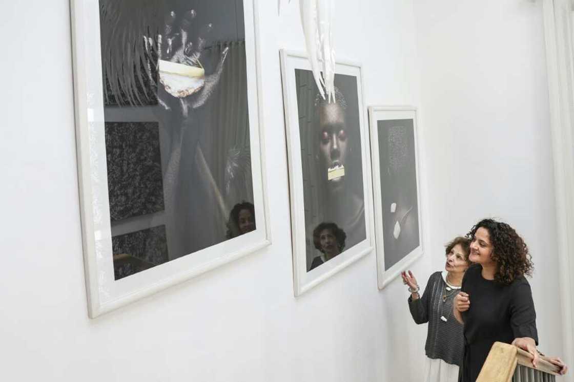 Shah (right) shows a client a display of a previous collection at her Nairobi studio Shah (right) shows a client a display of a previous collection at her Nairobi studio
