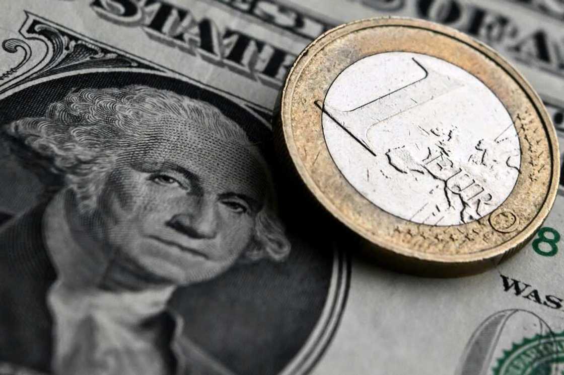 The euro hit a one-year dollar low on Tuesday, dropping below $1.06