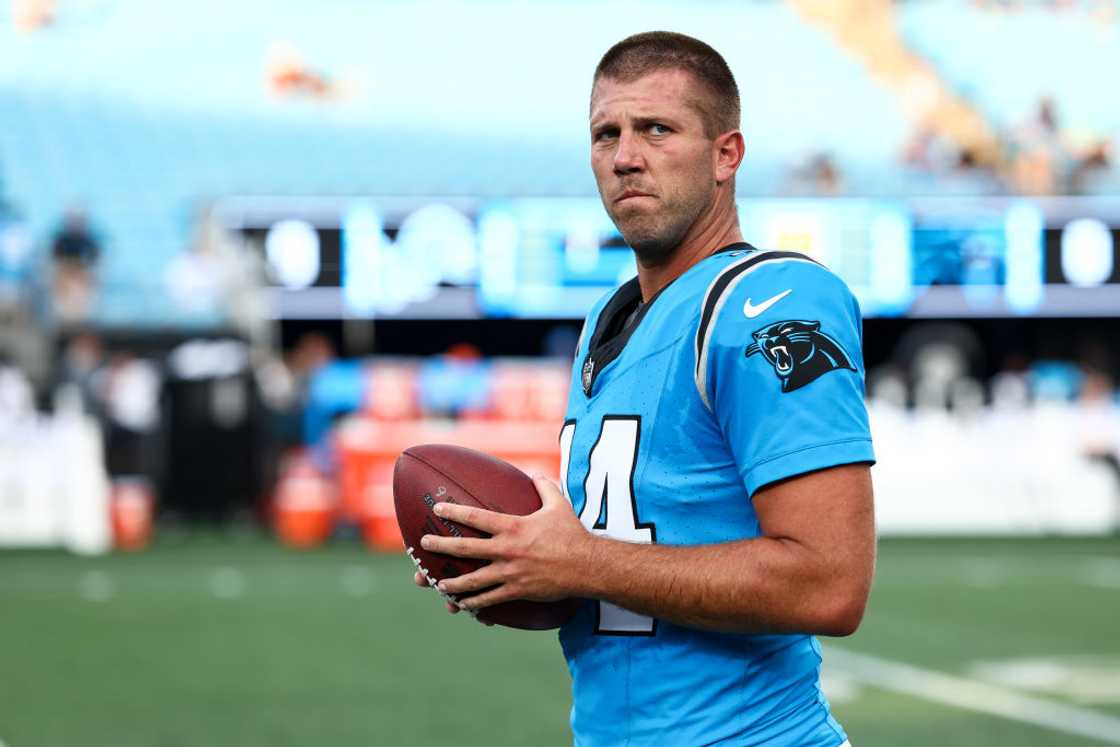 JJ Jansen #44 of the Carolina Panthers holds the ball during warms up