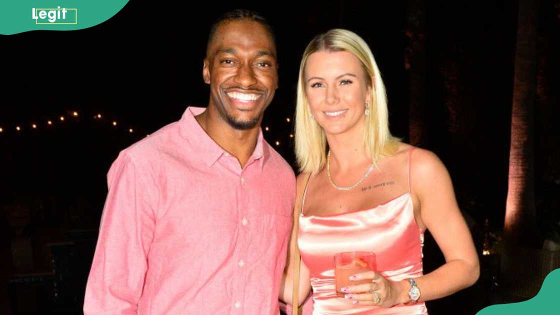 Robert Griffin III and Grete Šadeiko Griffin posing at The Volume Anniversary Party