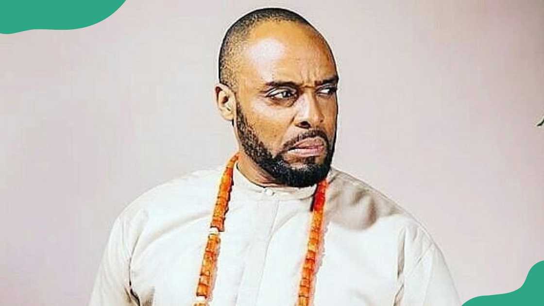 Kalu Ikeagwu in a white shirt with beads necklace.