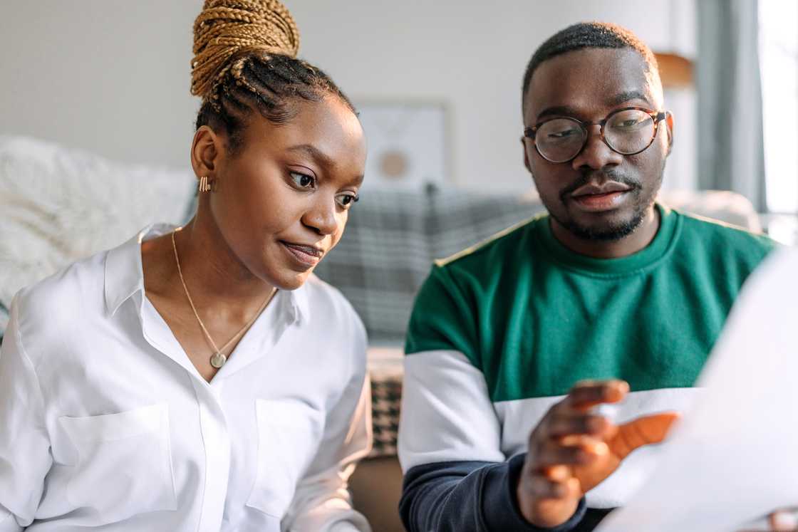 A young couple going over bills at their apartment