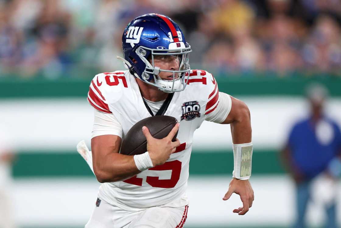 Tommy DeVito runs with the ball Tommy DeVito runs with the ball