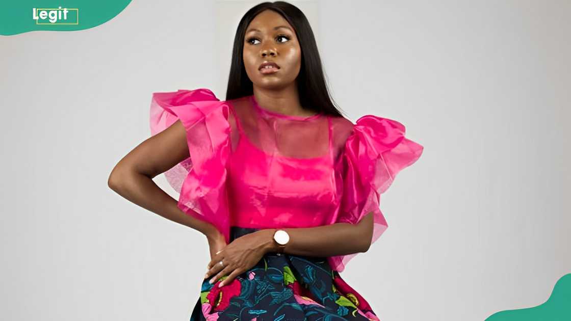 A lady wearing a pink flared sleeves organza top A lady wearing a pink flared sleeves organza top