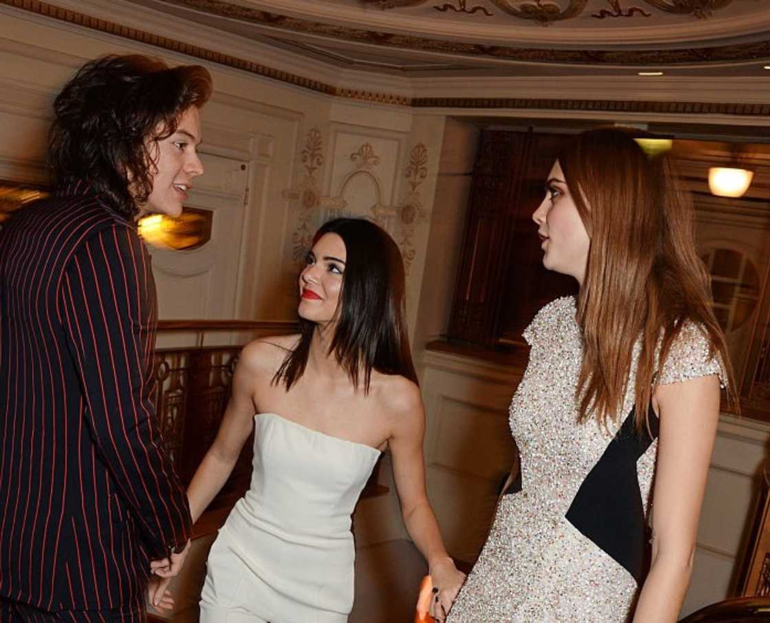 Harry Styles, Kendall Jenner, and Cara Delevingne having a conversation at the British Fashion Awards at the London Coliseum Harry Styles, Kendall Jenner, and Cara Delevingne having a conversation at the British Fashion Awards at the London Coliseum