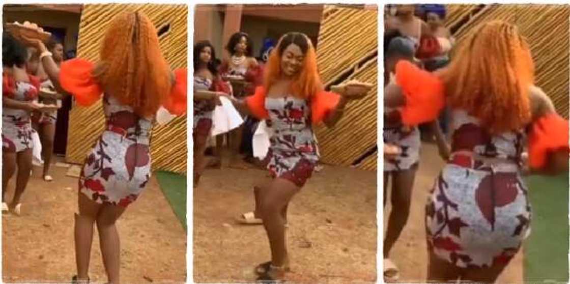 A Nigerian lady in short Ankara gown with basket in her hands danced very nicely at an Igbo traditional wedding, stealing the show A Nigerian lady in short Ankara gown with basket in her hands danced very nicely at an Igbo traditional wedding, stealing the show