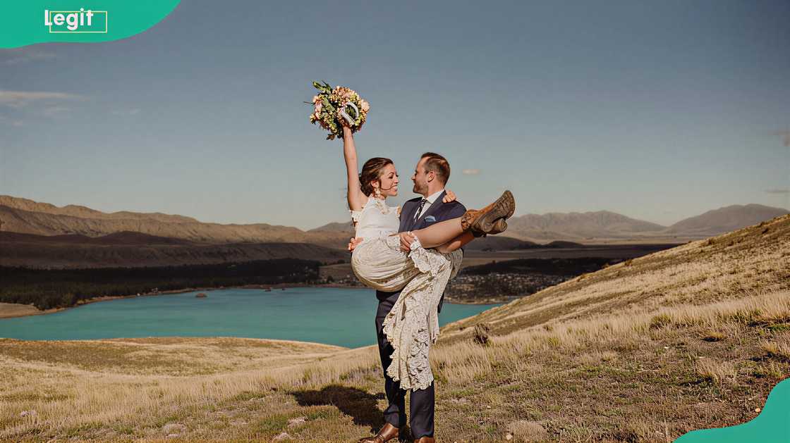 Remi Warren and Danielle Warren sharing a joyful moment beside a wide dam reservoir Remi Warren and Danielle Warren sharing a joyful moment beside a wide dam reservoir