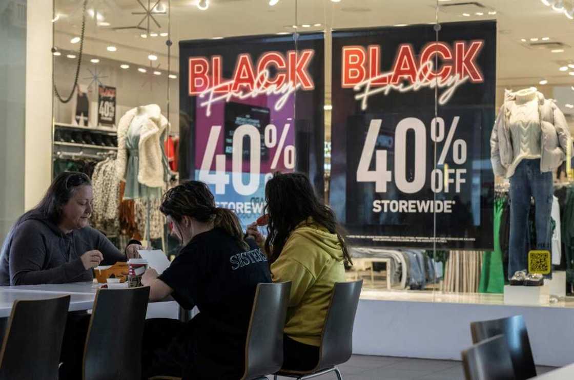 A family eats lunch near a store advertising a Black Friday sale at the Pentagon City Mall in Arlington, Virginia A family eats lunch near a store advertising a Black Friday sale at the Pentagon City Mall in Arlington, Virginia