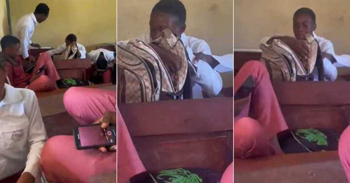 Secondary school boy opens bag in class Secondary school boy opens bag in class