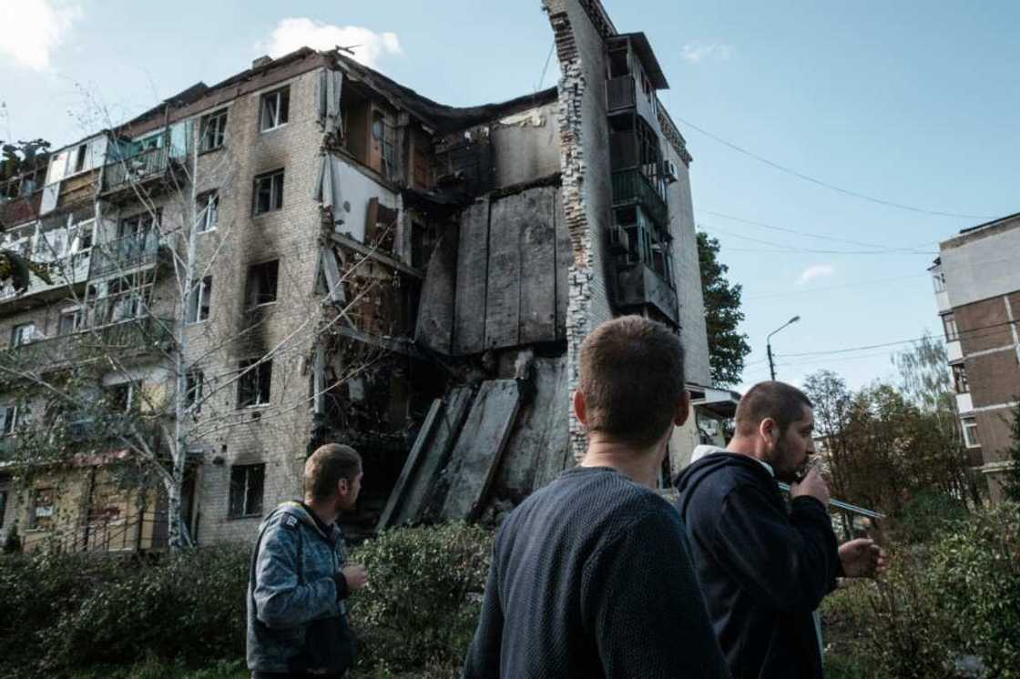 Residents of Bakhmut walk past destroyed residential buildings, with Russian forces advancing Residents of Bakhmut walk past destroyed residential buildings, with Russian forces advancing