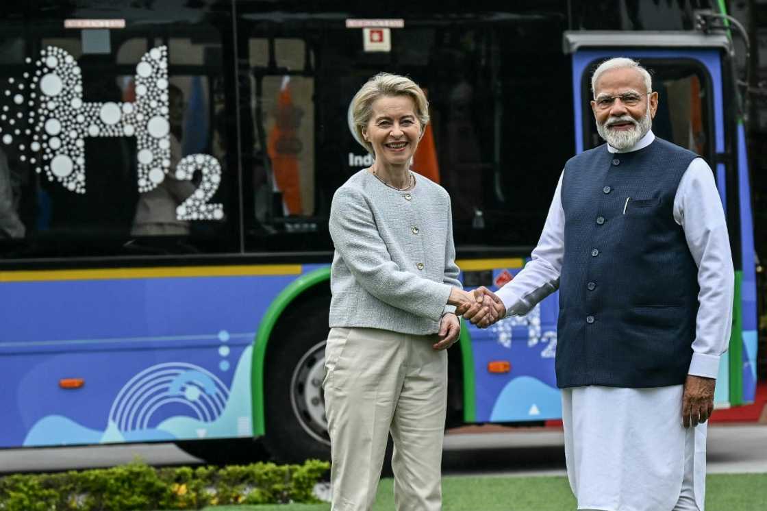 European Commission President Ursula von der Leyen (L) shakes hands with India's Prime Minister Narendra Modi as they stand in front of a hydrogen fuel cell bus before a meeting at Hyderabad House in New Delhi on February 28, 2025. The European Union is exploring a security and defence partnership with India, EU chief Ursula von der Leyen said on February 28 before meeting with Prime Minister Narendra Modi in New Delhi.