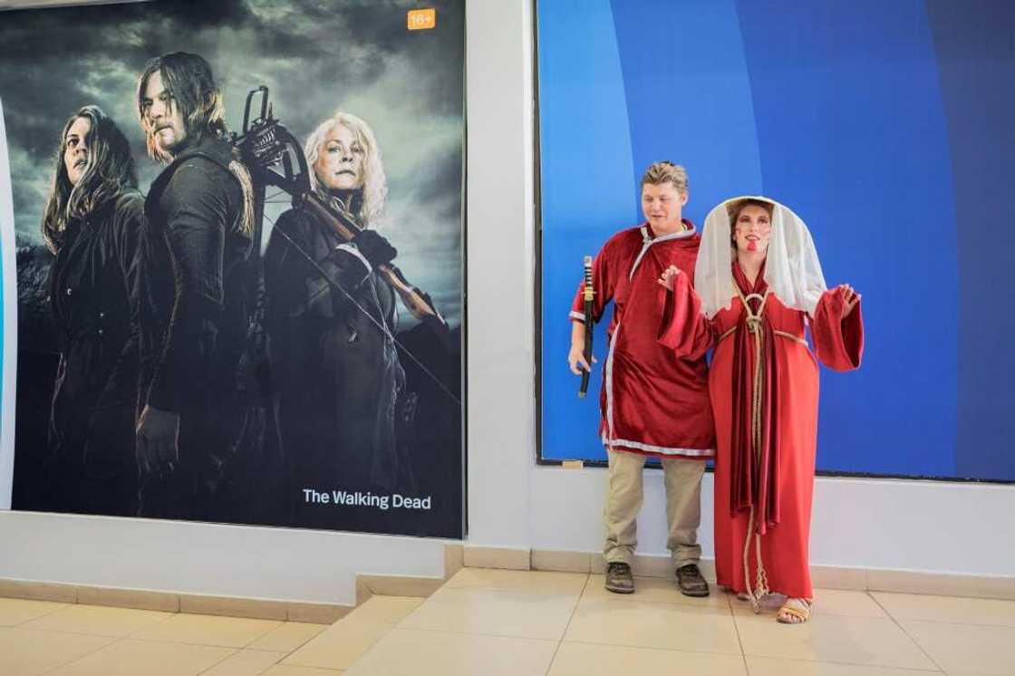 Amateur cosplayers pose at the entrance of Comic Con Africa Amateur cosplayers pose at the entrance of Comic Con Africa