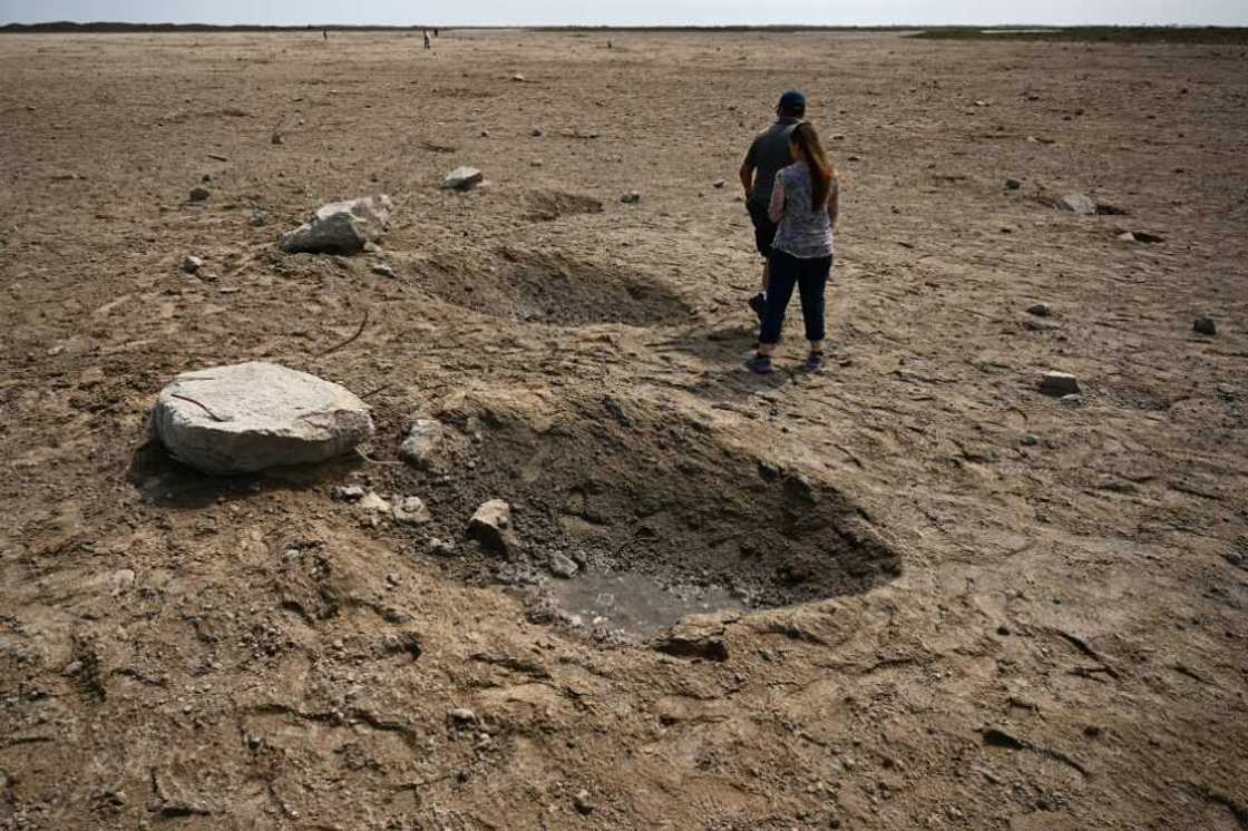 Members of the public walk through a debris field near the SpaceX launch pad on April 22, 2023 Members of the public walk through a debris field near the SpaceX launch pad on April 22, 2023