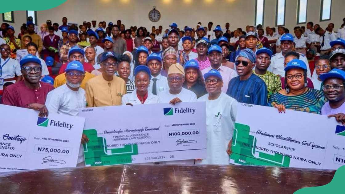 A group of Ondo State scholarship beneficiaries displays dummy cheques A group of Ondo State scholarship beneficiaries displays dummy cheques