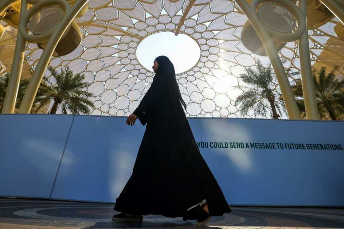 A woman walks through the COP28 site in Dubai