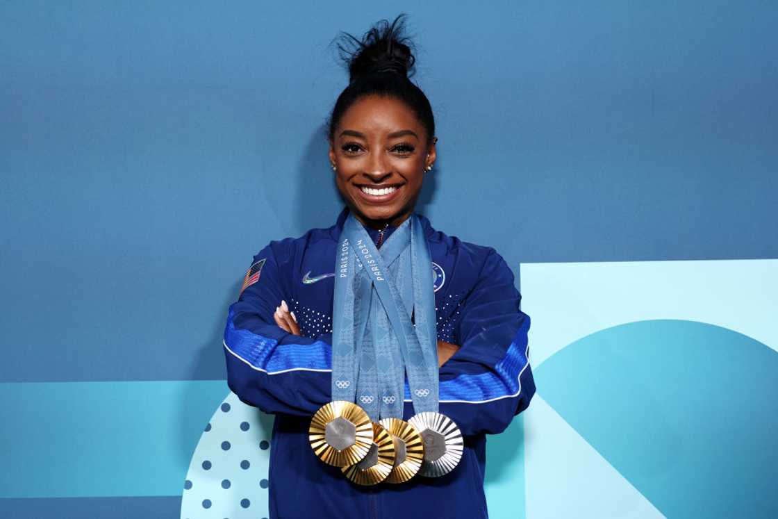 Simone Biles poses with her Paris 2024 Olympic medals Simone Biles poses with her Paris 2024 Olympic medals