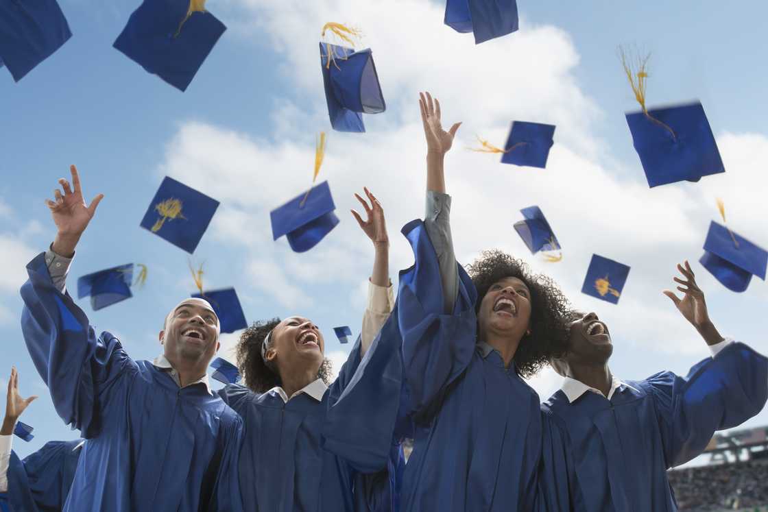 Students throwing caps at graduation